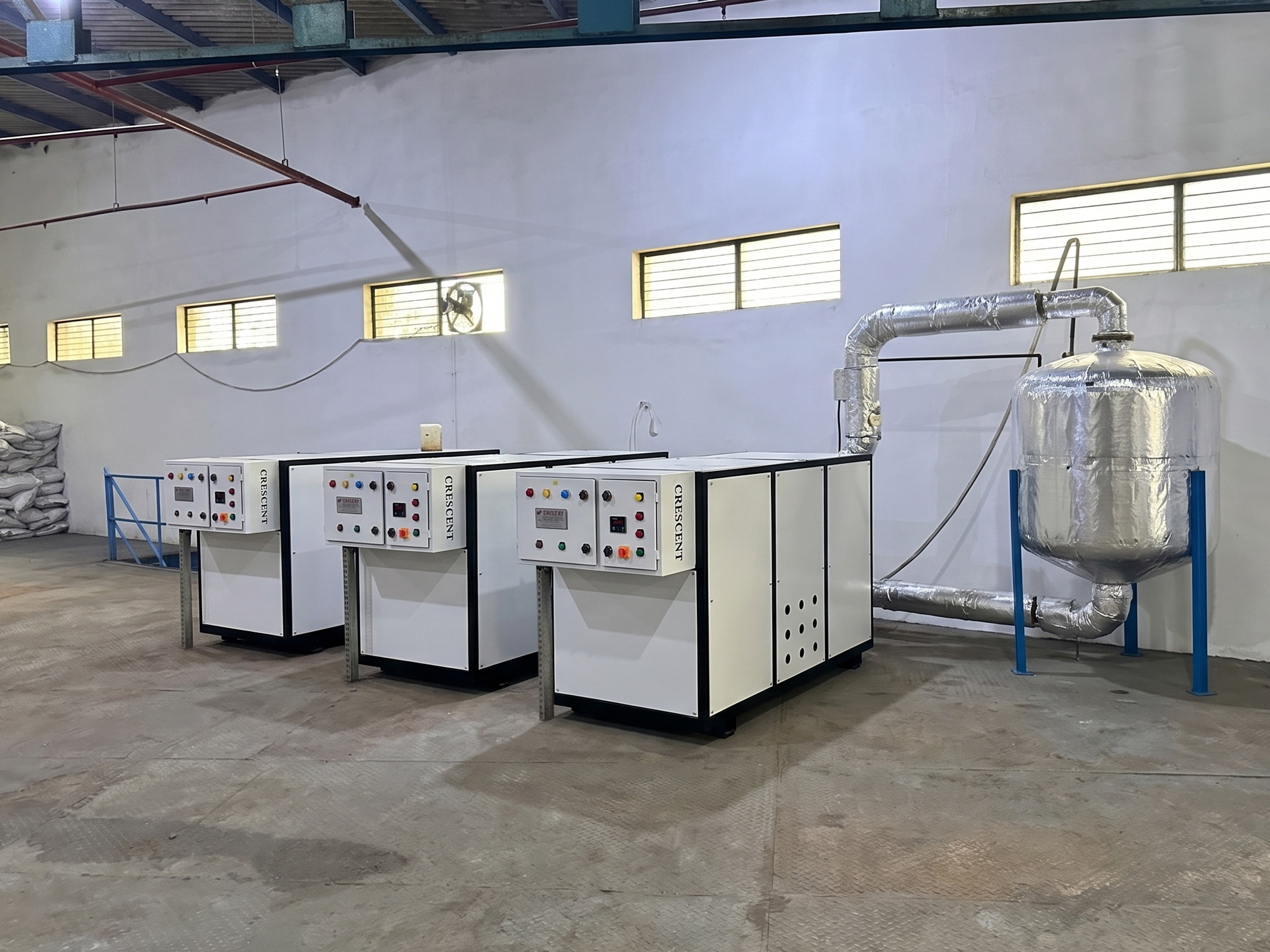 Row of industrial air-cooled chillers outdoors